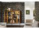 Stylish living room with bold wallpaper, hardwood flooring, and a unique display cabinet at 5969 S Humboldt Ct, Centennial, CO 80121