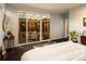 Bright main bedroom with large sliding glass doors leading to the home's patio at 5969 S Humboldt Ct, Centennial, CO 80121
