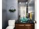 Chic powder room with unique glass sink and modern fixtures at 5969 S Humboldt Ct, Centennial, CO 80121
