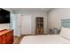 Bright bedroom featuring a storage closet, an entertainment unit, and wood-look flooring at 2870 S Ursula St, Aurora, CO 80014