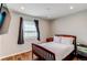 This bedroom offers a window to bring light into the space and wood look flooring at 2870 S Ursula St, Aurora, CO 80014
