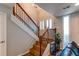 Inviting entryway with wood stairs, a white handrail with iron spindles and bright natural light at 2870 S Ursula St, Aurora, CO 80014