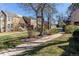 Well-maintained front yard and common area of townhomes with sidewalks and mature trees at 2870 S Ursula St, Aurora, CO 80014