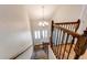 Hallway with chandelier and stairs leading to the second floor with carpet runner at 2870 S Ursula St, Aurora, CO 80014