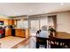 Bright and spacious kitchen featuring a dining table, sliding glass doors, and wood cabinets at 2870 S Ursula St, Aurora, CO 80014