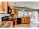 Bright kitchen with stainless steel appliances, stone countertops, and hardwood cabinets at 2870 S Ursula St, Aurora, CO 80014