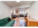 Open-concept area featuring two distinct living areas, with hardwood floors and sunny windows at 2870 S Ursula St, Aurora, CO 80014