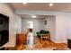 Spacious living area featuring wood floors, a desk, a futon, and an opening to the kitchen at 2870 S Ursula St, Aurora, CO 80014