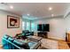 Cozy living room with recessed lighting, hardwood floors, and comfortable leather seating arrangement at 2870 S Ursula St, Aurora, CO 80014