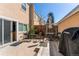 Back patio with black metal table and chairs with black covered barbeque at 2870 S Ursula St, Aurora, CO 80014