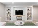 Finished basement featuring custom built-ins with shelving, media storage, and a wall-mounted television at 6681 Secrest Cir, Arvada, CO 80007