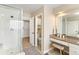 Bathroom with a glass enclosed shower, granite countertop vanity, and neutral tile at 6681 Secrest Cir, Arvada, CO 80007