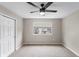 Carpeted bedroom with a ceiling fan, window, and closet for optimal storage at 6681 Secrest Cir, Arvada, CO 80007