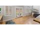 Bright dining area boasts hardwood floors and white French doors that provide backyard access and natural light at 6681 Secrest Cir, Arvada, CO 80007