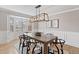 Elegant dining room with natural light, modern light fixture, and seating for six at 6681 Secrest Cir, Arvada, CO 80007