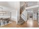 Inviting entryway featuring hardwood floors, staircase with wood and iron railings, and dining room view at 6681 Secrest Cir, Arvada, CO 80007