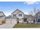 Charming two-story home with a manicured lawn, a two car garage, and solar panels at 6681 Secrest Cir, Arvada, CO 80007