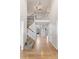 Bright foyer featuring hardwood floors, staircase with iron railings, and a view into the living area at 6681 Secrest Cir, Arvada, CO 80007