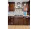 Close-up of the kitchen gas cooktop with custom cabinetry and stone counters at 6681 Secrest Cir, Arvada, CO 80007