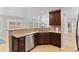 Bright kitchen featuring stone counters, a dishwasher, and wood cabinets at 6681 Secrest Cir, Arvada, CO 80007