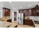 Spacious kitchen with granite countertops and stainless steel refrigerator at 6681 Secrest Cir, Arvada, CO 80007