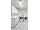 Well-organized laundry room featuring modern appliances, cabinetry, stylish tile flooring, and ample counter space at 6681 Secrest Cir, Arvada, CO 80007