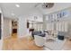 Bright living room with hardwood floors, a high vaulted ceiling, and large windows with white shutters at 6681 Secrest Cir, Arvada, CO 80007