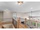 Upstairs loft featuring wood floors, iron railings, abundant light, and views of the home's layout at 6681 Secrest Cir, Arvada, CO 80007
