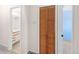 Hallway with a view into the bathroom and a wooden bi-fold closet door at 3740 Iris Ave # B, Boulder, CO 80301