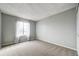 Carpeted bedroom with grey walls and a window at 4750 S Dudley St # 7, Littleton, CO 80123