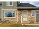 Green townhome with stone accents and front door at 4750 S Dudley St # 7, Littleton, CO 80123