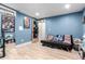 Multipurpose basement room with a futon and recreational corner, with blue walls at 1977 S Oakland Way, Aurora, CO 80014