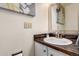 Cozy bathroom featuring a mirror and sink with a marble countertop at 1977 S Oakland Way, Aurora, CO 80014