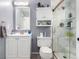 Bathroom boasting a sink, toilet, and shower with marble tile and glass doors and a modern vanity at 1977 S Oakland Way, Aurora, CO 80014
