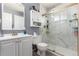 Bathroom features a sink, toilet, and shower with marble tile and glass doors at 1977 S Oakland Way, Aurora, CO 80014