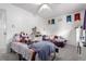Bright bedroom featuring a ceiling fan, two beds, and banners on the wall at 1977 S Oakland Way, Aurora, CO 80014