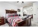 Bedroom boasts a wooden bed frame, bedside table, plush comforter, and a mirrored closet door at 1977 S Oakland Way, Aurora, CO 80014