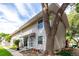 Inviting townhouse exterior with mature trees, enhancing curb appeal and providing shade at 1977 S Oakland Way, Aurora, CO 80014