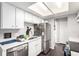 Kitchen featuring white cabinetry, stainless steel appliances, and a modern sink and faucet at 1977 S Oakland Way, Aurora, CO 80014