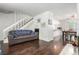 Open-concept living area with hardwood floors, staircase, and view to dining space at 1977 S Oakland Way, Aurora, CO 80014
