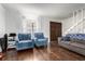 Bright living room featuring hardwood floors, comfortable seating, and ample natural light at 1977 S Oakland Way, Aurora, CO 80014