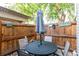 Cozy outdoor patio with a table, chairs, and a fenced-in area for privacy at 1977 S Oakland Way, Aurora, CO 80014