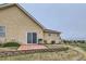 Backyard patio with grill and low brick wall in grassy yard with view of the surrounding neighborhood at 1335 Villa Grv # 30, Monument, CO 80132