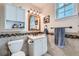 Cozy bathroom featuring a tiled backsplash, framed mirror, and storage for a functional design at 1335 Villa Grv # 30, Monument, CO 80132