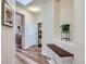 Hallway with wood floors leading to living area, featuring console table and decorative plant at 1335 Villa Grv # 30, Monument, CO 80132