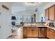 Bright eat-in kitchen with stainless appliances flows into a spacious living area with fireplace and vaulted ceilings at 1335 Villa Grv # 30, Monument, CO 80132