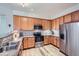 Well-equipped kitchen features stainless steel appliances and warm wooden cabinets for a modern feel at 1335 Villa Grv # 30, Monument, CO 80132