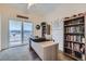 Bright office space with a standing desk, balcony access, and built-in shelving for optimal organization at 1335 Villa Grv # 30, Monument, CO 80132