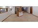 Spacious carpeted basement with a bar area including a sink and cabinet, ideal for entertaining at 2045 Pine Wood Rd, Sedalia, CO 80135
