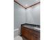 Powder room featuring wood cabinet, dark countertop and a white toilet at 2045 Pine Wood Rd, Sedalia, CO 80135